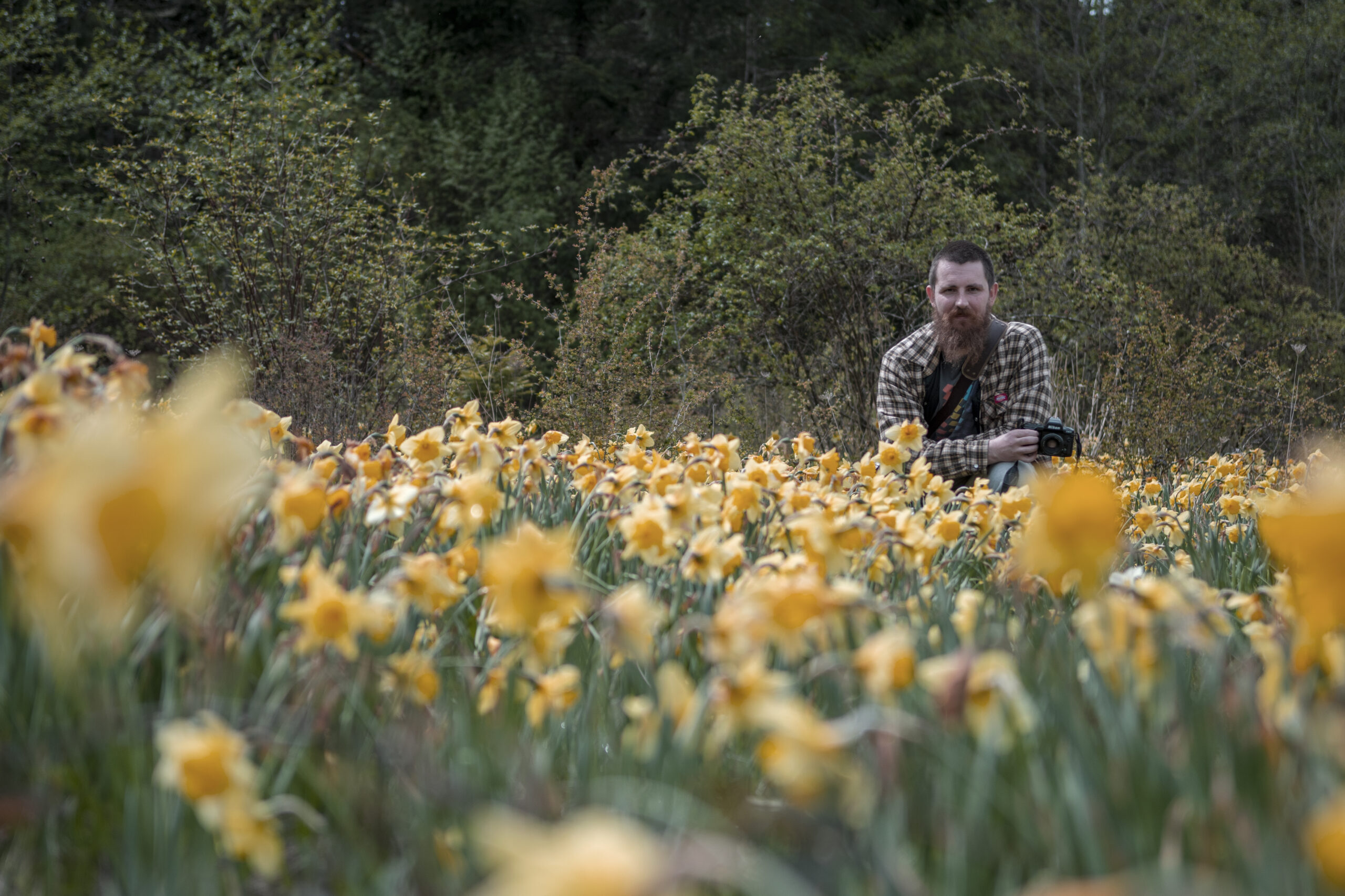 grant de gagne with camera in field of flowers